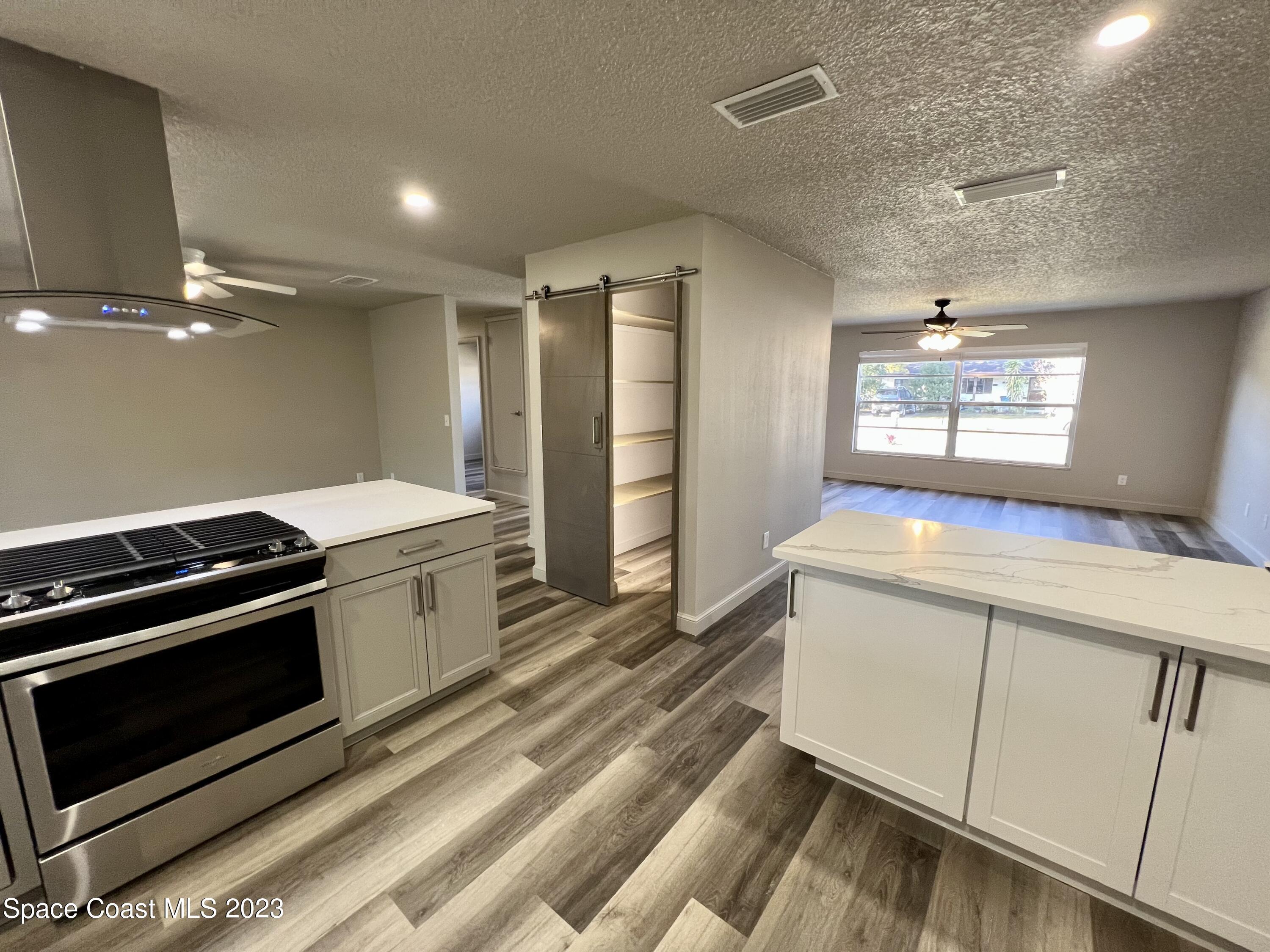 1095 Coronado Drive Rockledge, FL 32955 - Photo 10 of 28 a kitchen with a stove and a sink
