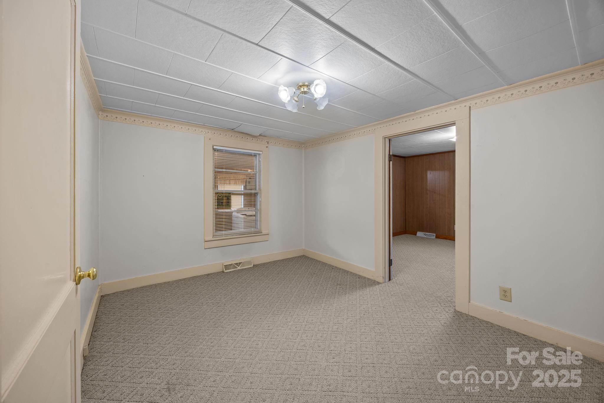3020 Old Union Church Road Salisbury, NC 28146 - Photo 19 of 48 an empty room with chandelier fan and windows