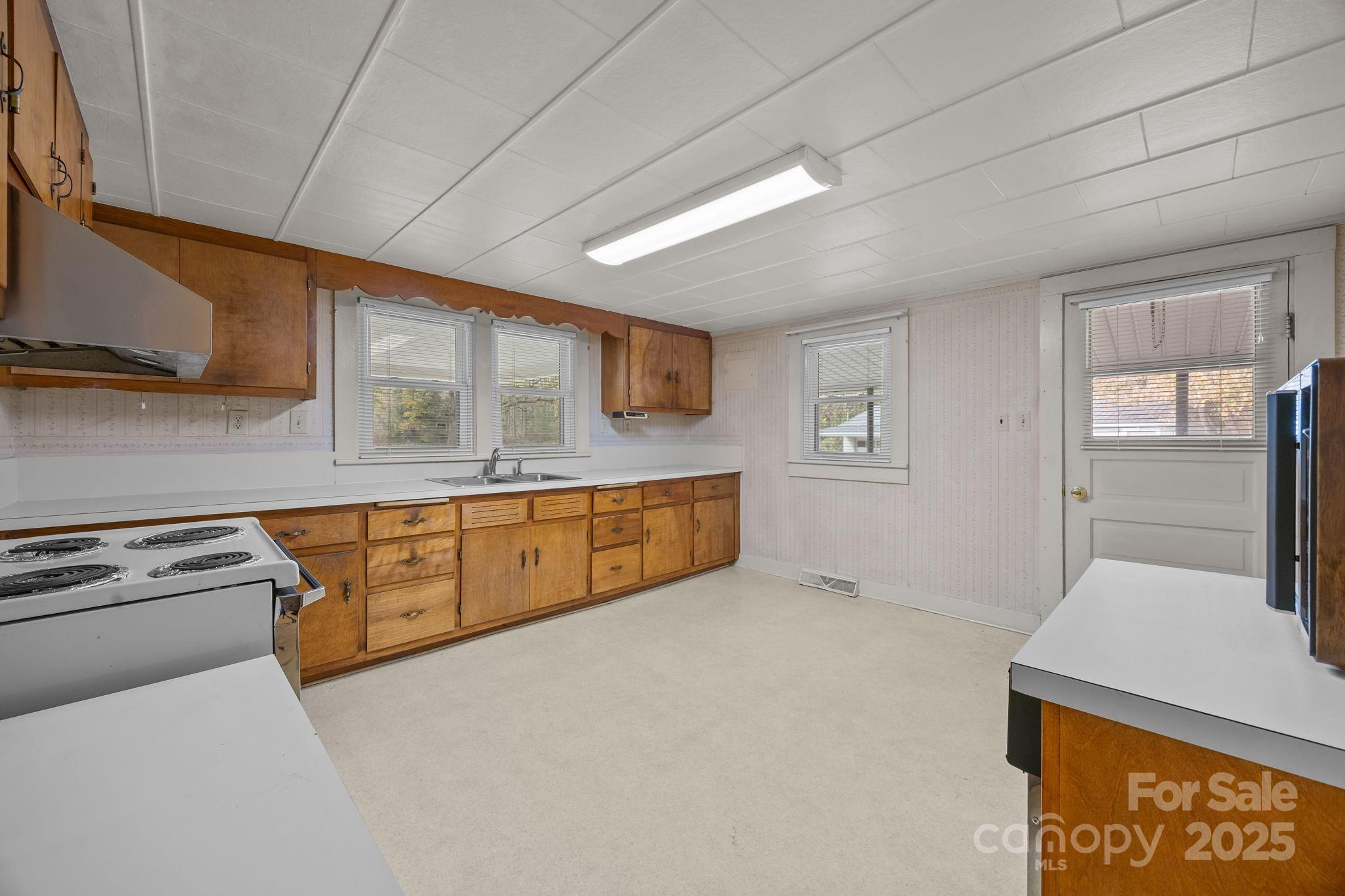 3020 Old Union Church Road Salisbury, NC 28146 - Photo 24 of 48 a kitchen with stainless steel appliances granite countertop a sink a stove and a refrigerator