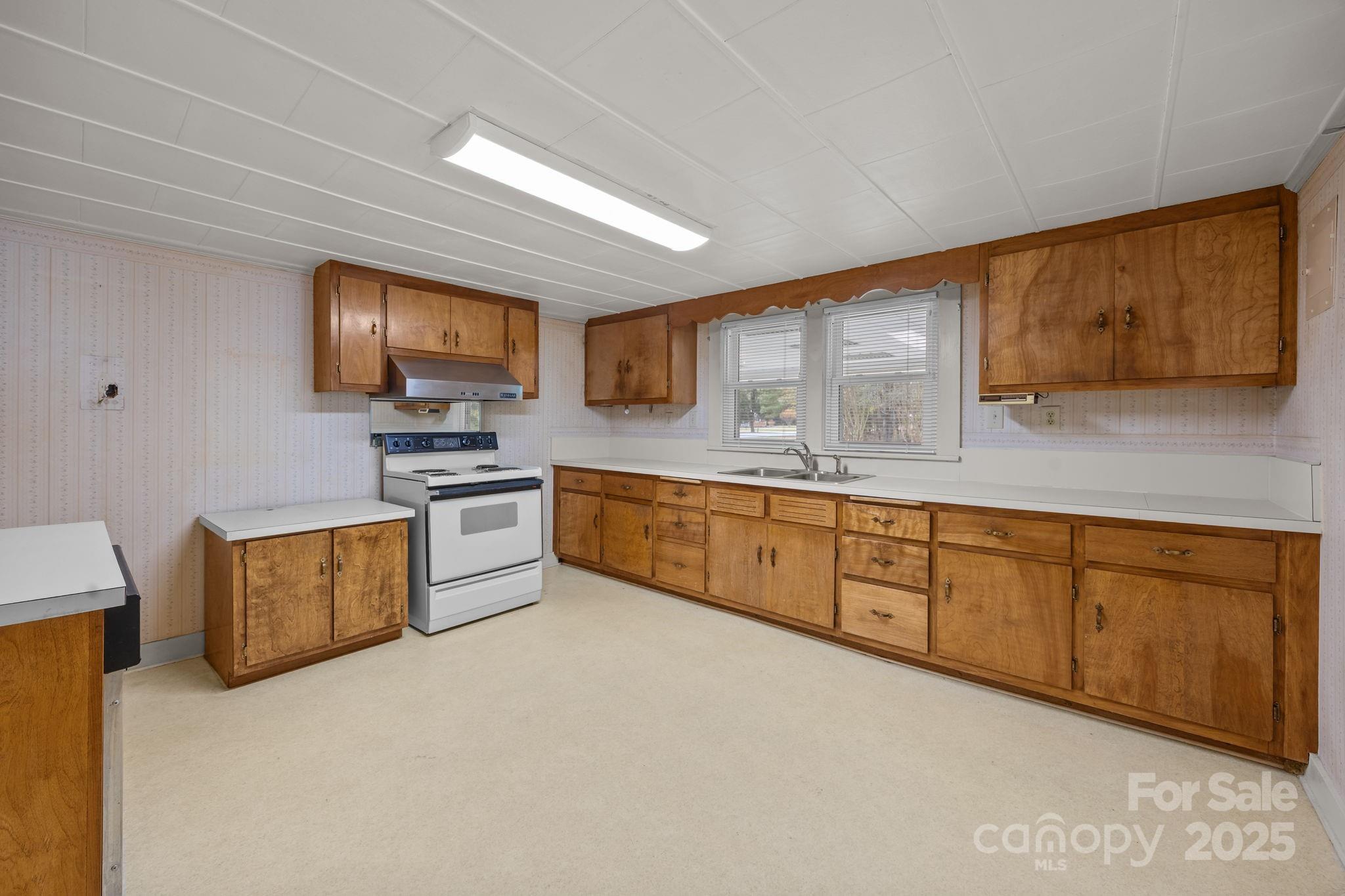 3020 Old Union Church Road Salisbury, NC 28146 - Photo 25 of 48 a large kitchen with stainless steel appliances granite countertop a stove a sink dishwasher a microwave oven with cabinets and wooden floor