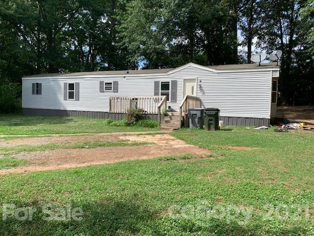 1220 Woodridge Road, Unit 5 Clover, SC 29710 - Photo 1 of 9 a front view of a house with a yard and trees