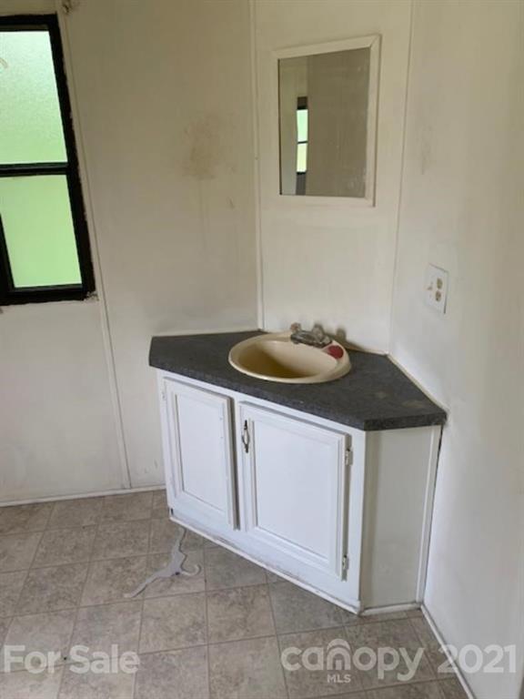 1220 Woodridge Road, Unit 5 Clover, SC 29710 - Photo 5 of 9 a bathroom with a sink and a mirror