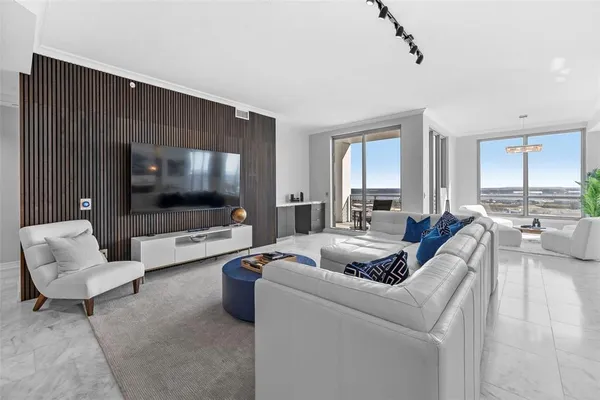 a living room with furniture and a floor to ceiling window