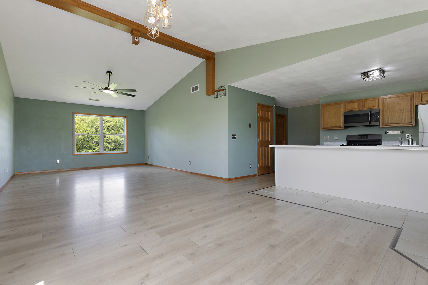 10050 Skipperling Road, Unit 1 Roscoe, IL 61073 - Photo 2 of 15 a view of a kitchen with a dishwasher cabinets and a wooden floor