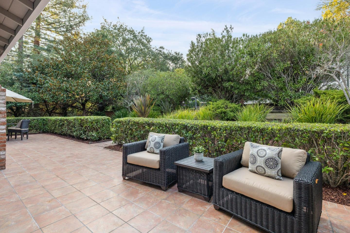 16 Valley Road Atherton, CA 94027 - Photo 59 of 100 a view of a patio with couches and a table and chairs with wooden fence
