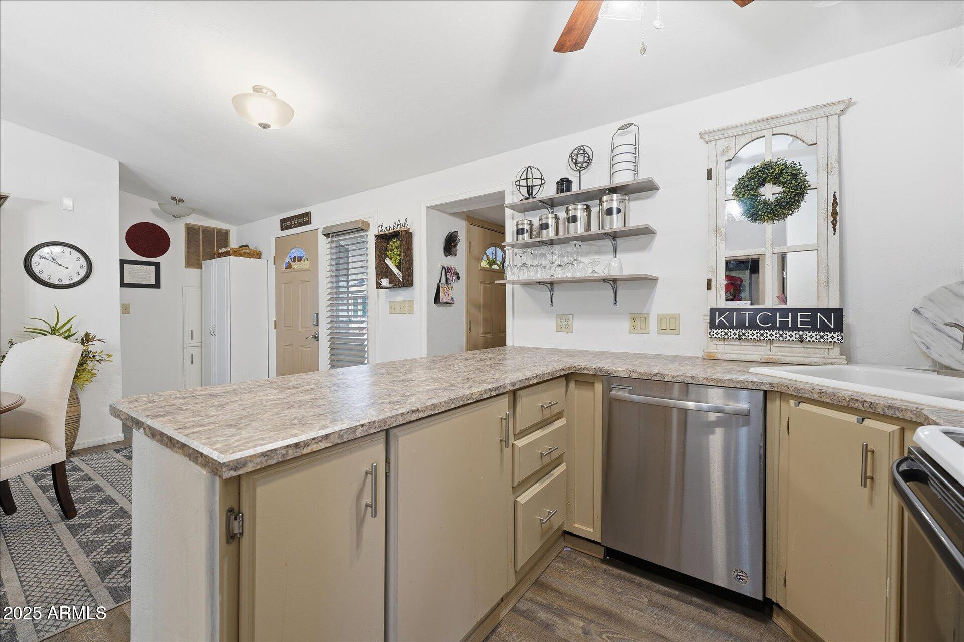 5735 East McDowell Road, Unit 243 Mesa, AZ 85215 - Photo 14 of 42 a kitchen with a sink stove and cabinets