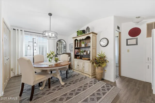 a view of a dining room with furniture and chandelier