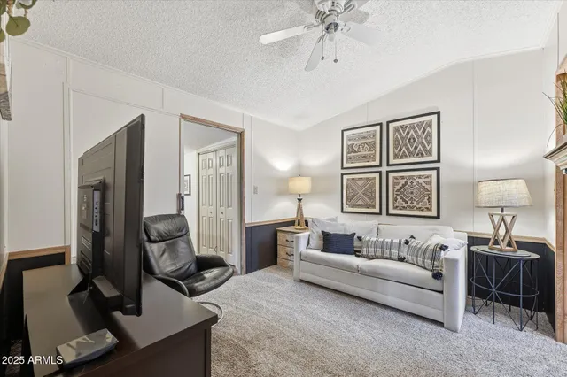 a spacious bedroom with a bed a couch and dresser