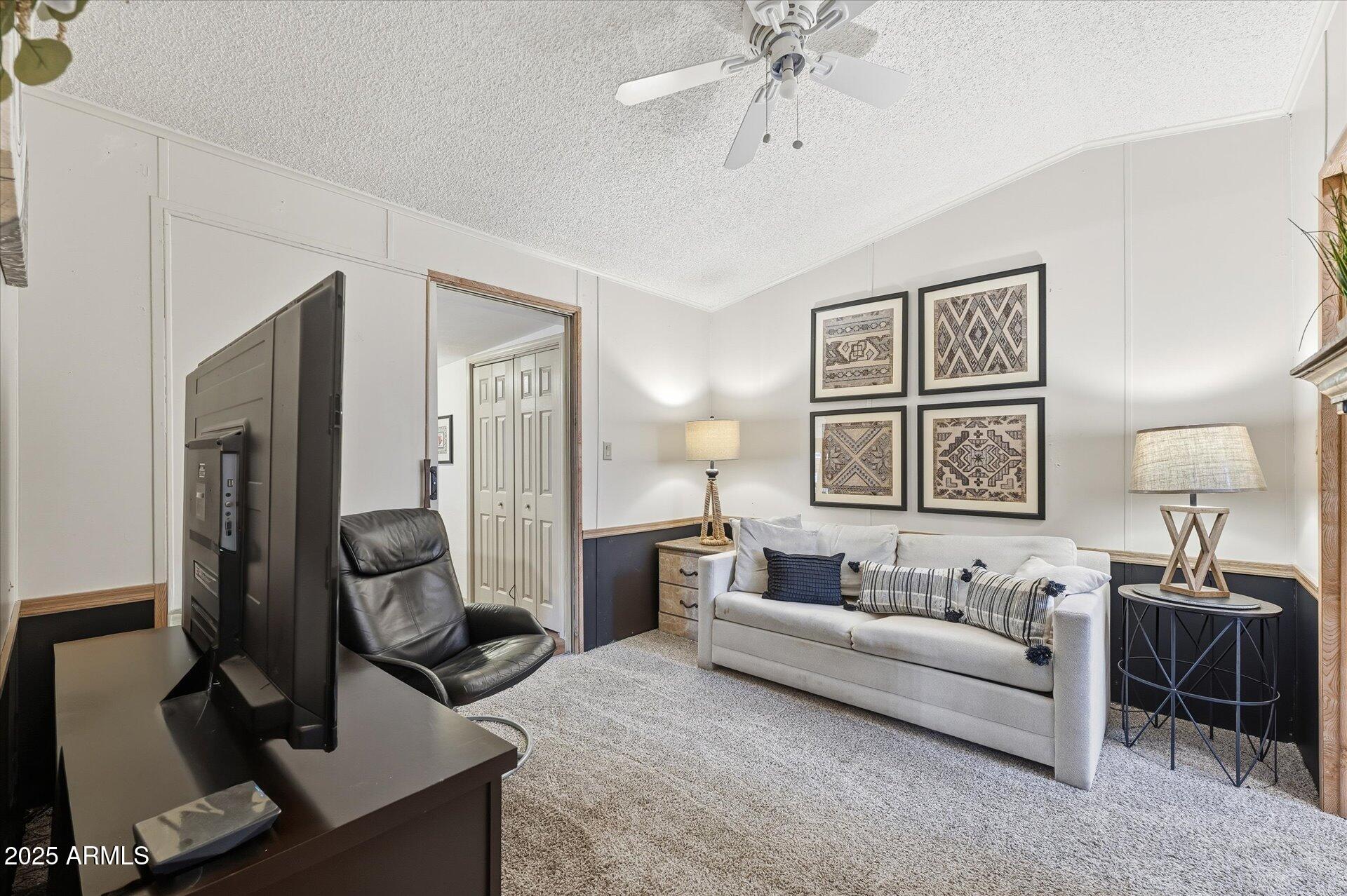 5735 East McDowell Road, Unit 243 Mesa, AZ 85215 - Photo 18 of 42 a spacious bedroom with a bed a couch and dresser
