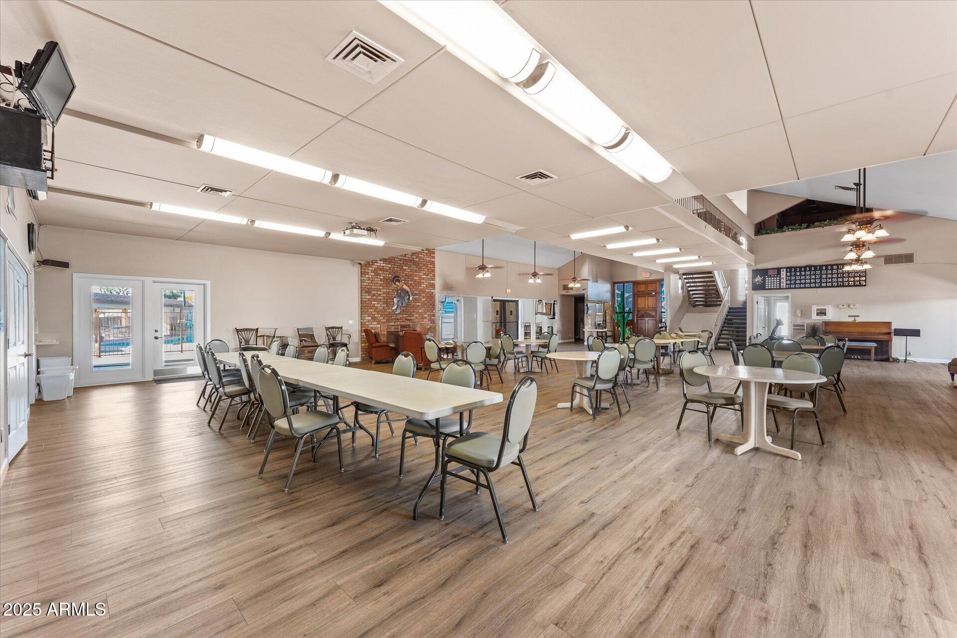 5735 East McDowell Road, Unit 243 Mesa, AZ 85215 - Photo 26 of 42 a view of a dining room with furniture and wooden floor