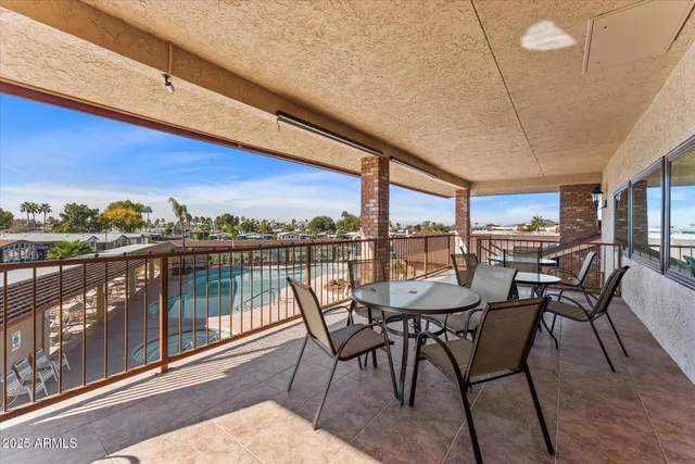 a view of a chairs and table in the balcony