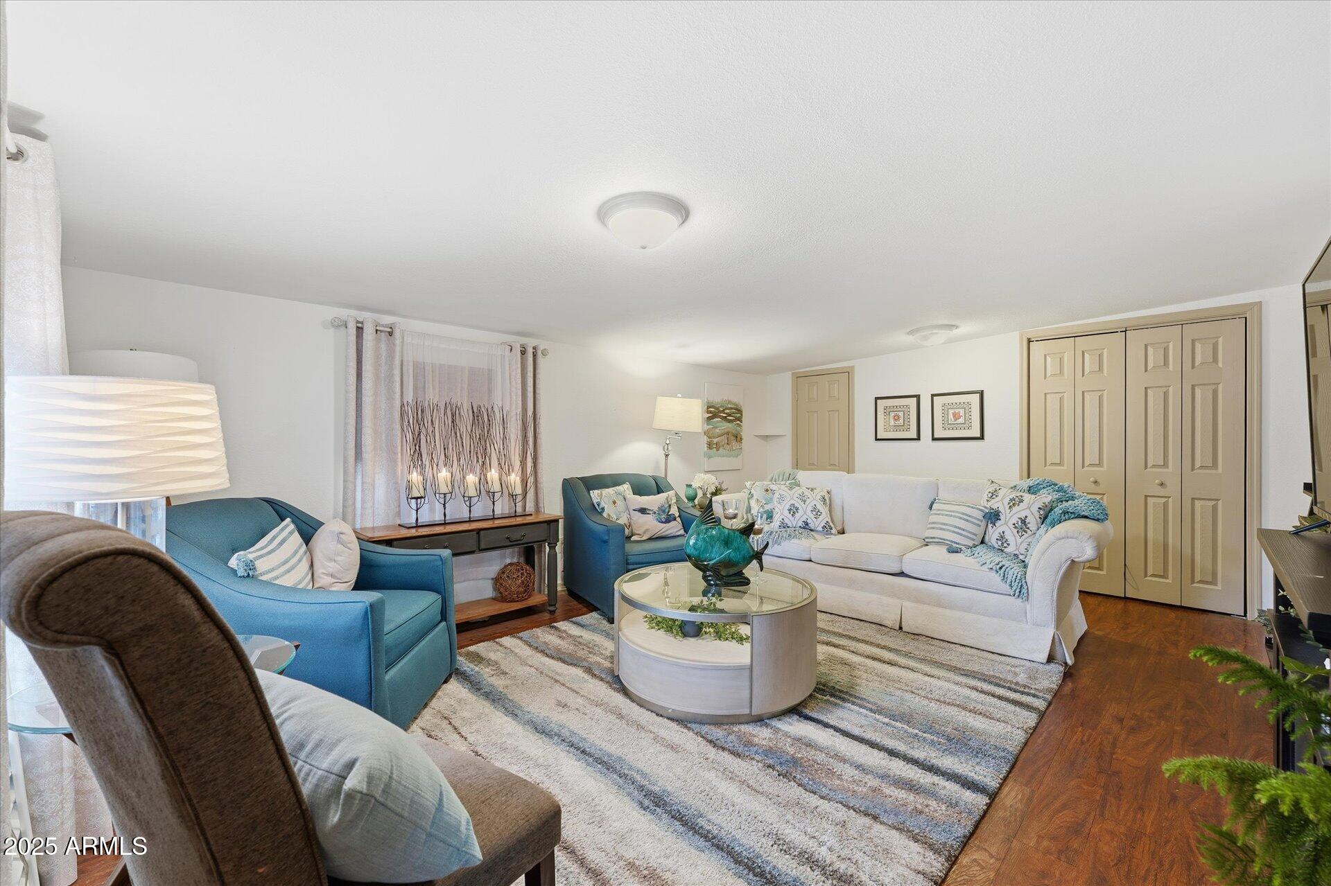 5735 East McDowell Road, Unit 243 Mesa, AZ 85215 - Photo 7 of 42 a living room with furniture and a large window