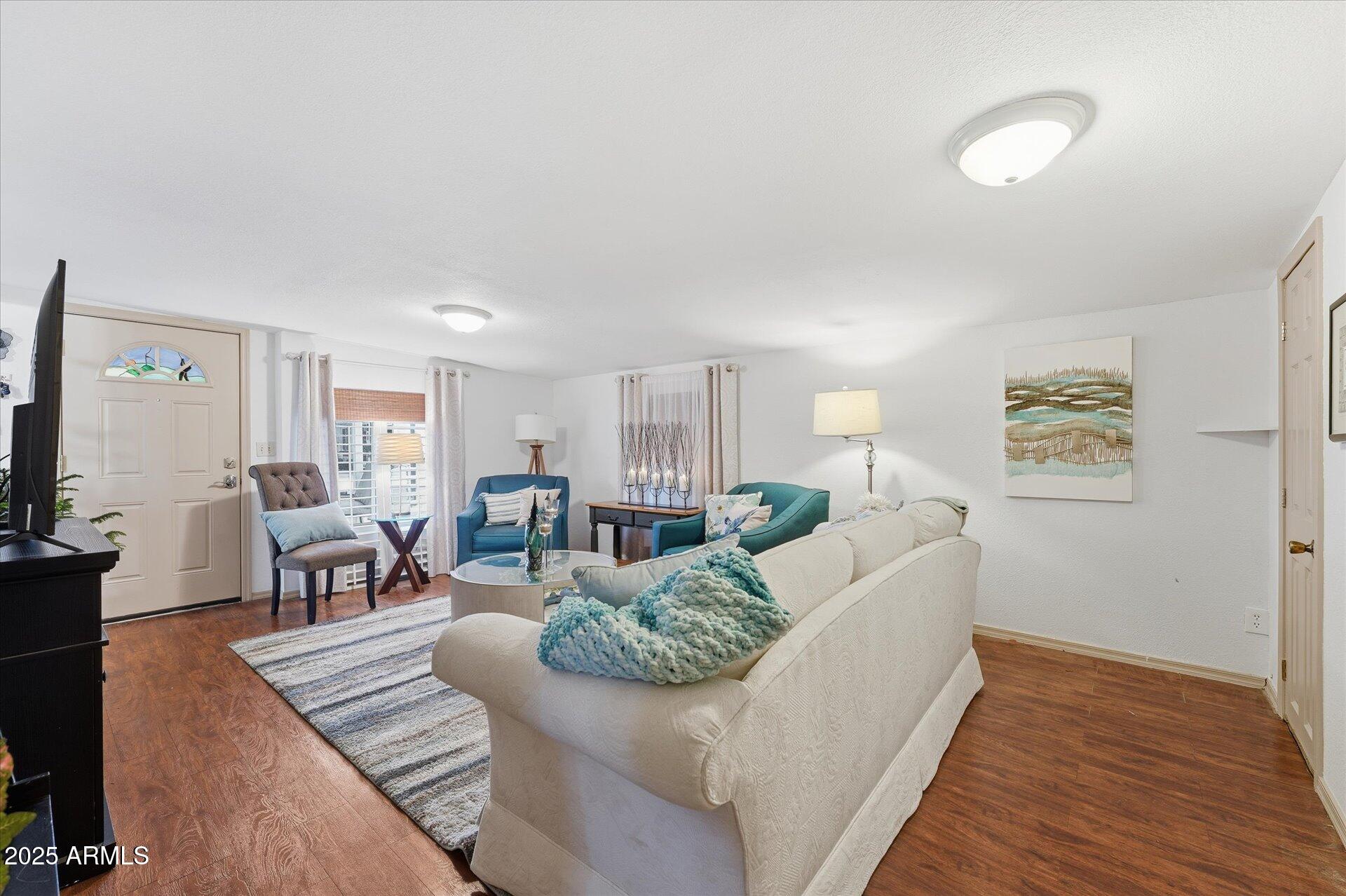 5735 East McDowell Road, Unit 243 Mesa, AZ 85215 - Photo 8 of 42 a living room with furniture and a flat screen tv