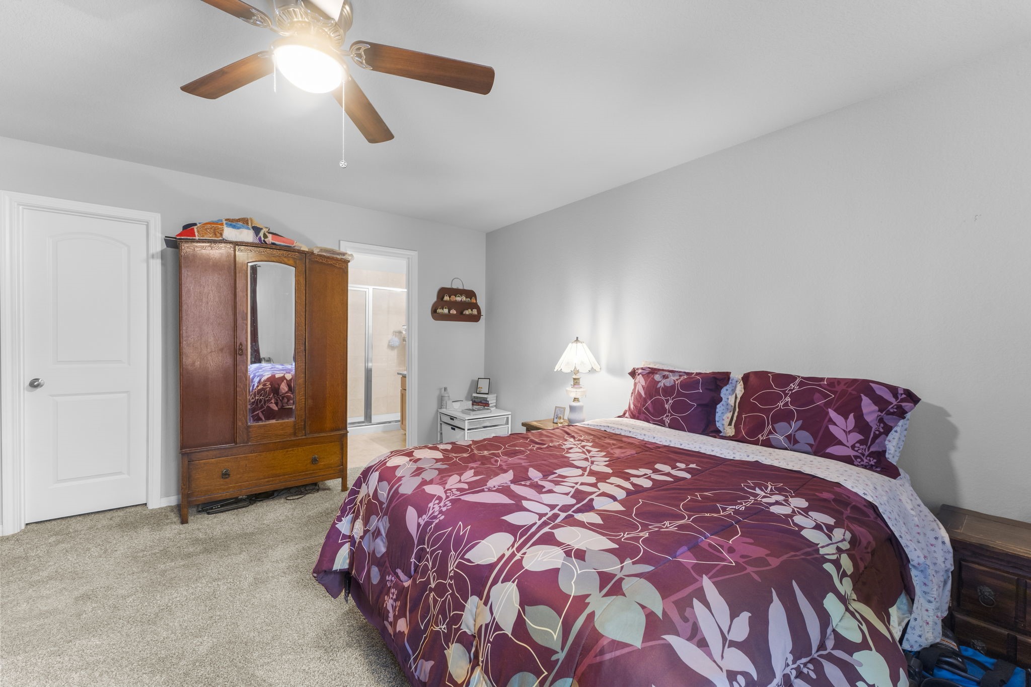 15120 Arrowhead Loop East Willis, TX 77378 - Photo 10 of 22 a bedroom with a large bed and a chandelier