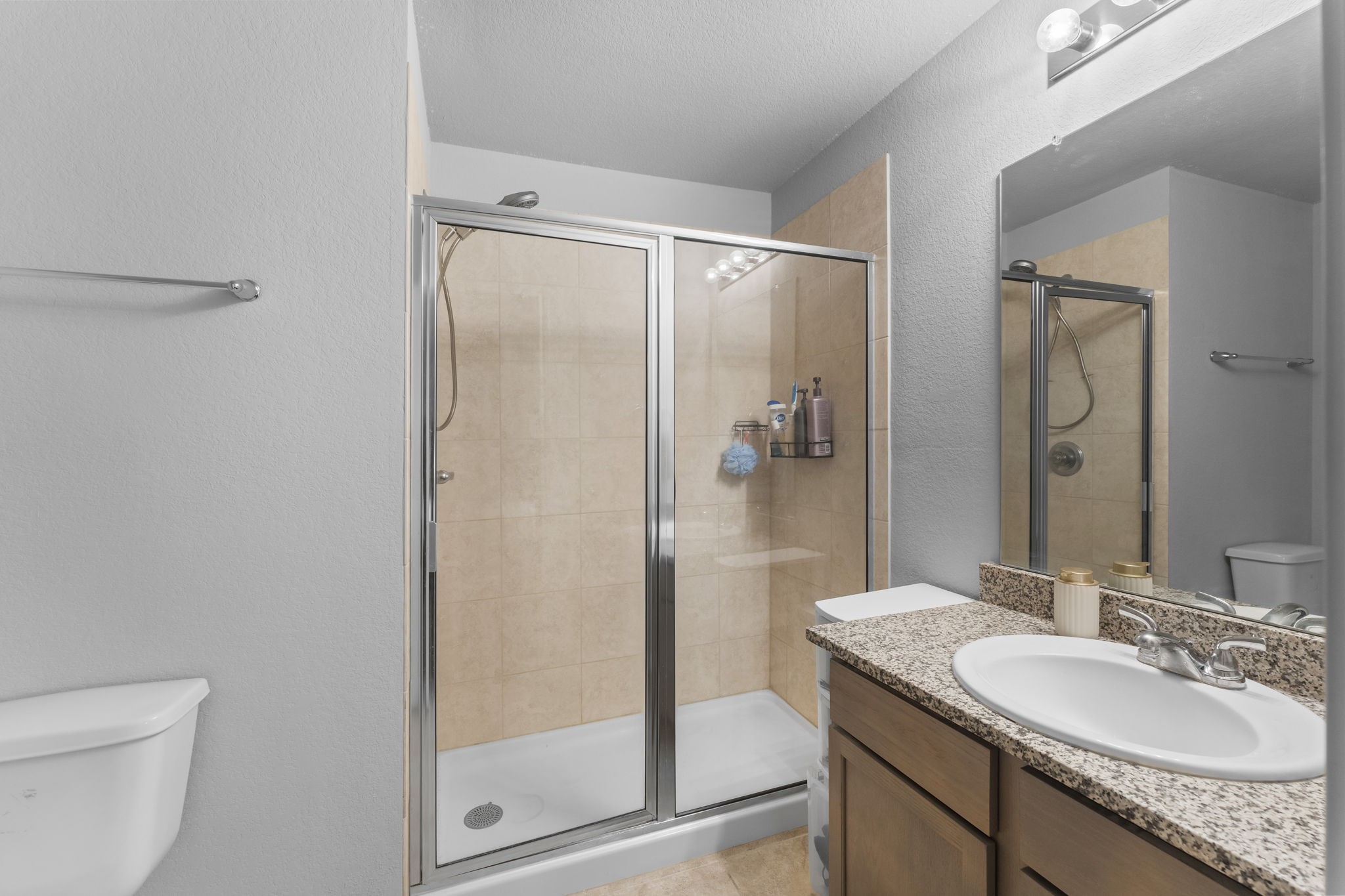 15120 Arrowhead Loop East Willis, TX 77378 - Photo 11 of 22 a bathroom with a granite countertop sink toilet and shower