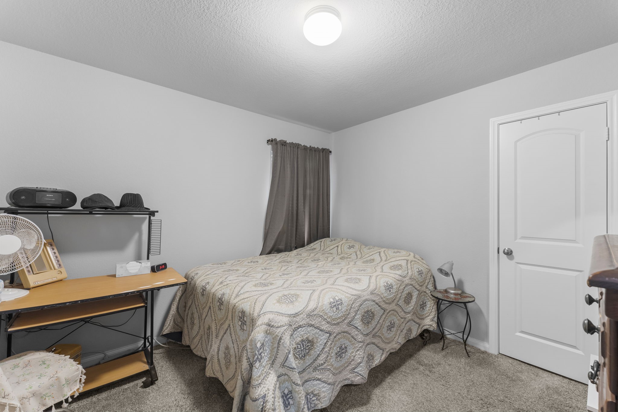 15120 Arrowhead Loop East Willis, TX 77378 - Photo 14 of 22 a bedroom with a bed and wooden floor