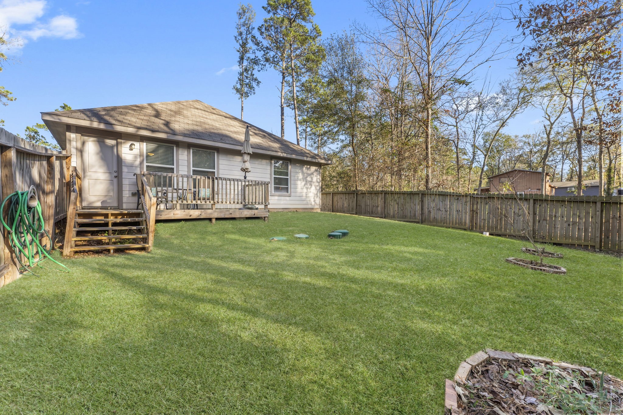 15120 Arrowhead Loop East Willis, TX 77378 - Photo 16 of 22 a view of a house with a yard and sitting area