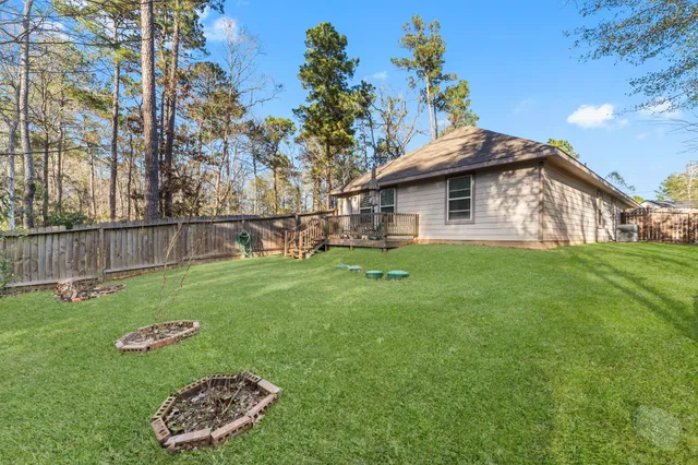 a view of a house with a yard and sitting area