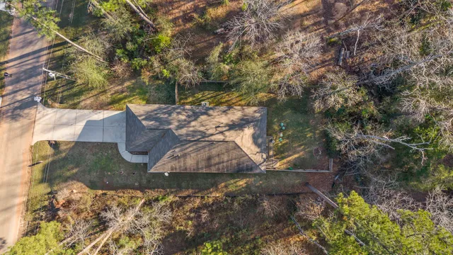 a view of a house with a yard and sitting area