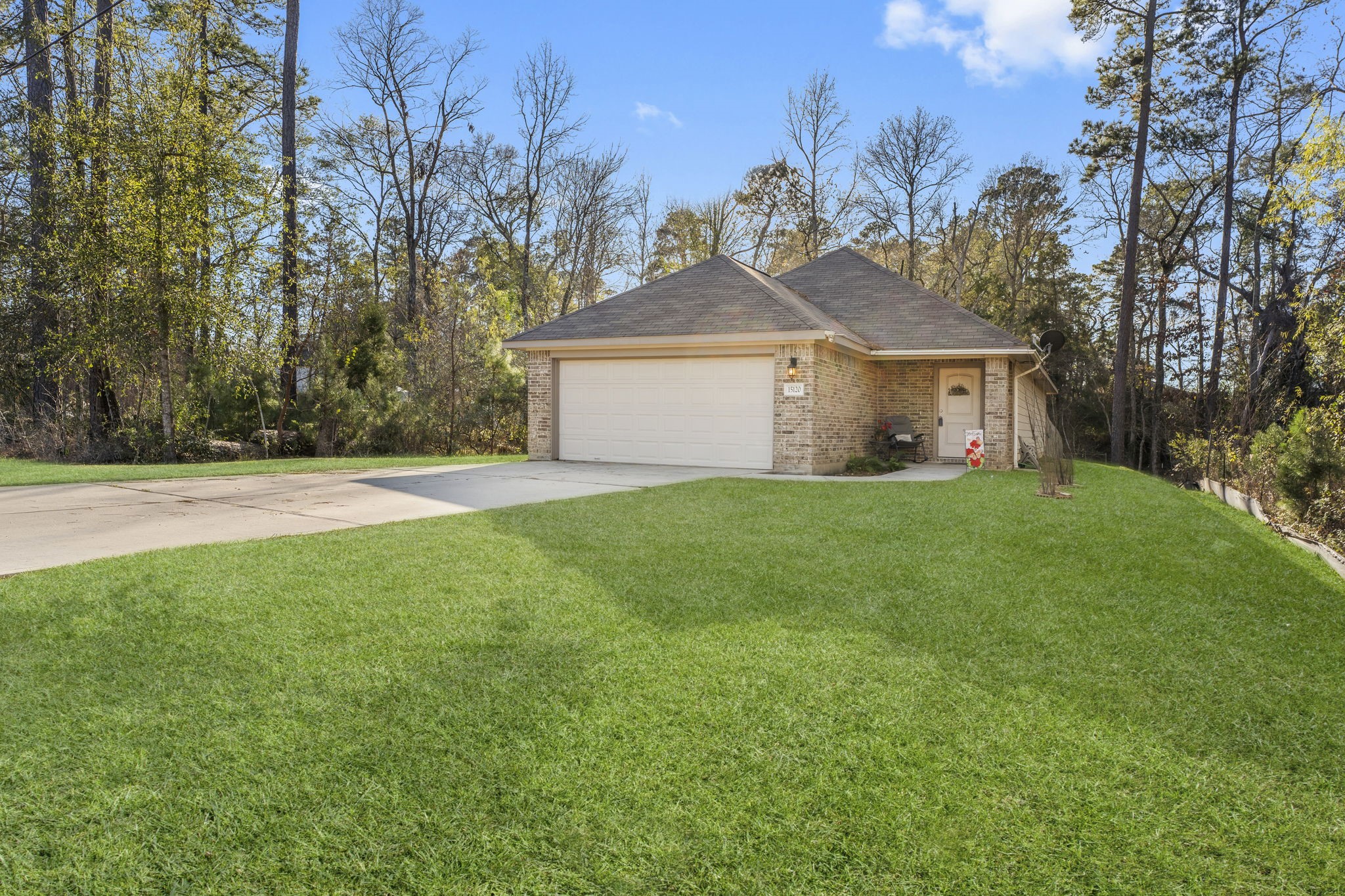 15120 Arrowhead Loop East Willis, TX 77378 - Photo 2 of 22 a front view of a house with yard and green space