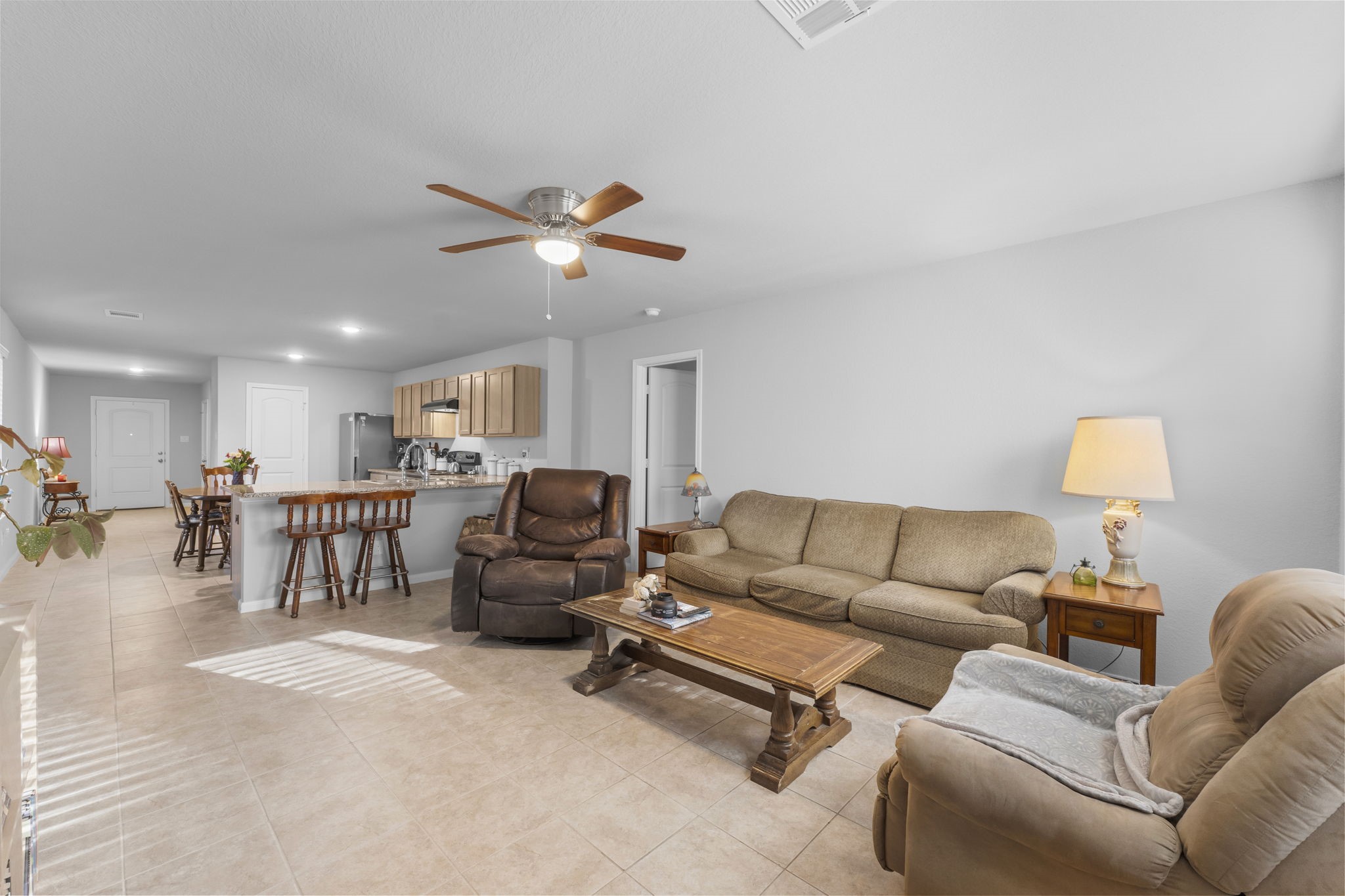 15120 Arrowhead Loop East Willis, TX 77378 - Photo 8 of 22 a living room with furniture a couch and a chandelier