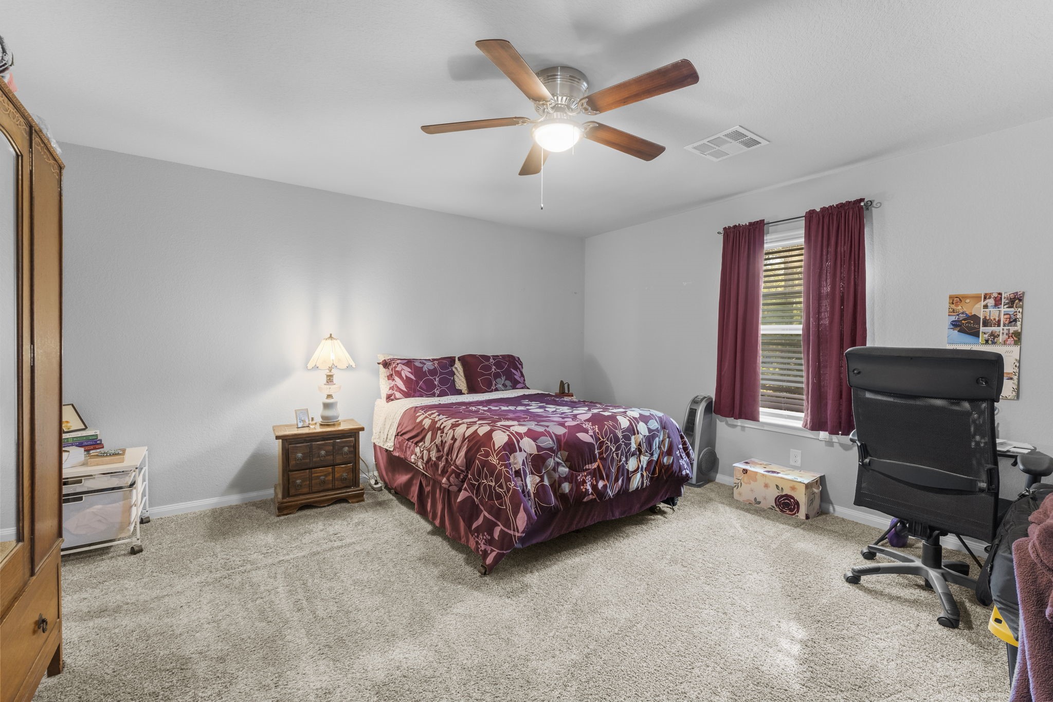 15120 Arrowhead Loop East Willis, TX 77378 - Photo 22 of 22 a bedroom with a bed and a chandelier