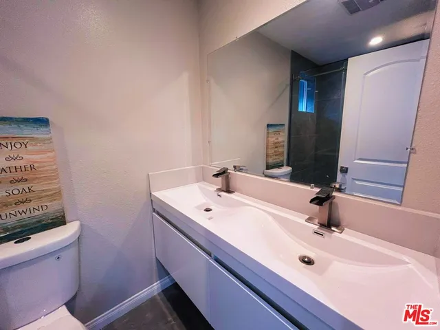 a bathroom with a double vanity sink and a mirror