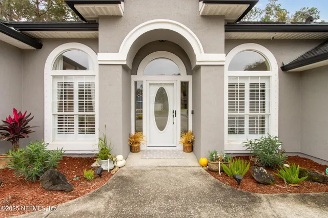 a hallway with windows and chandelier