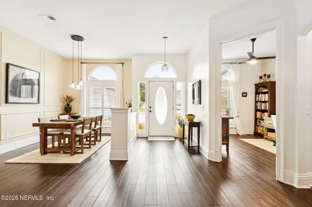 a view of a a dining room with furniture window and wooden floor