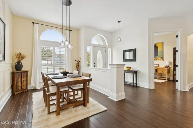 a living room with furniture wooden floor and a large window