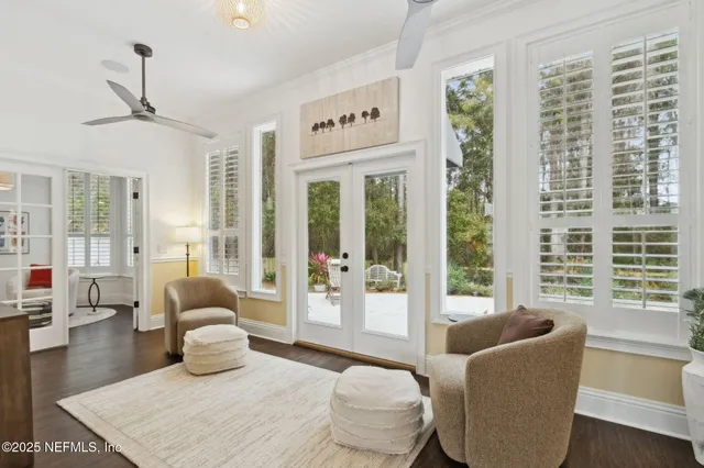 a living room with furniture a rug and a chandelier