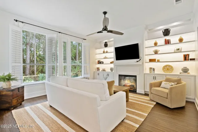 a living room with furniture a fireplace and a flat screen tv