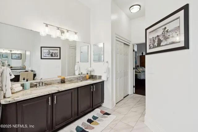 a bathroom with a granite countertop sink a toilet and shower