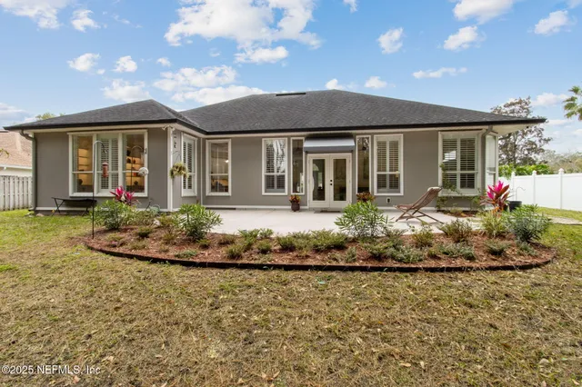 a front view of a house with a garden and plants