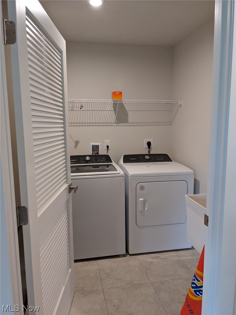174 West Spring Drive Elyria, OH 44035 - Photo 16 of 19 Clothes washing area with hookup for an electric dryer, sink, light tile floors, washer and clothes dryer, and washer hookup