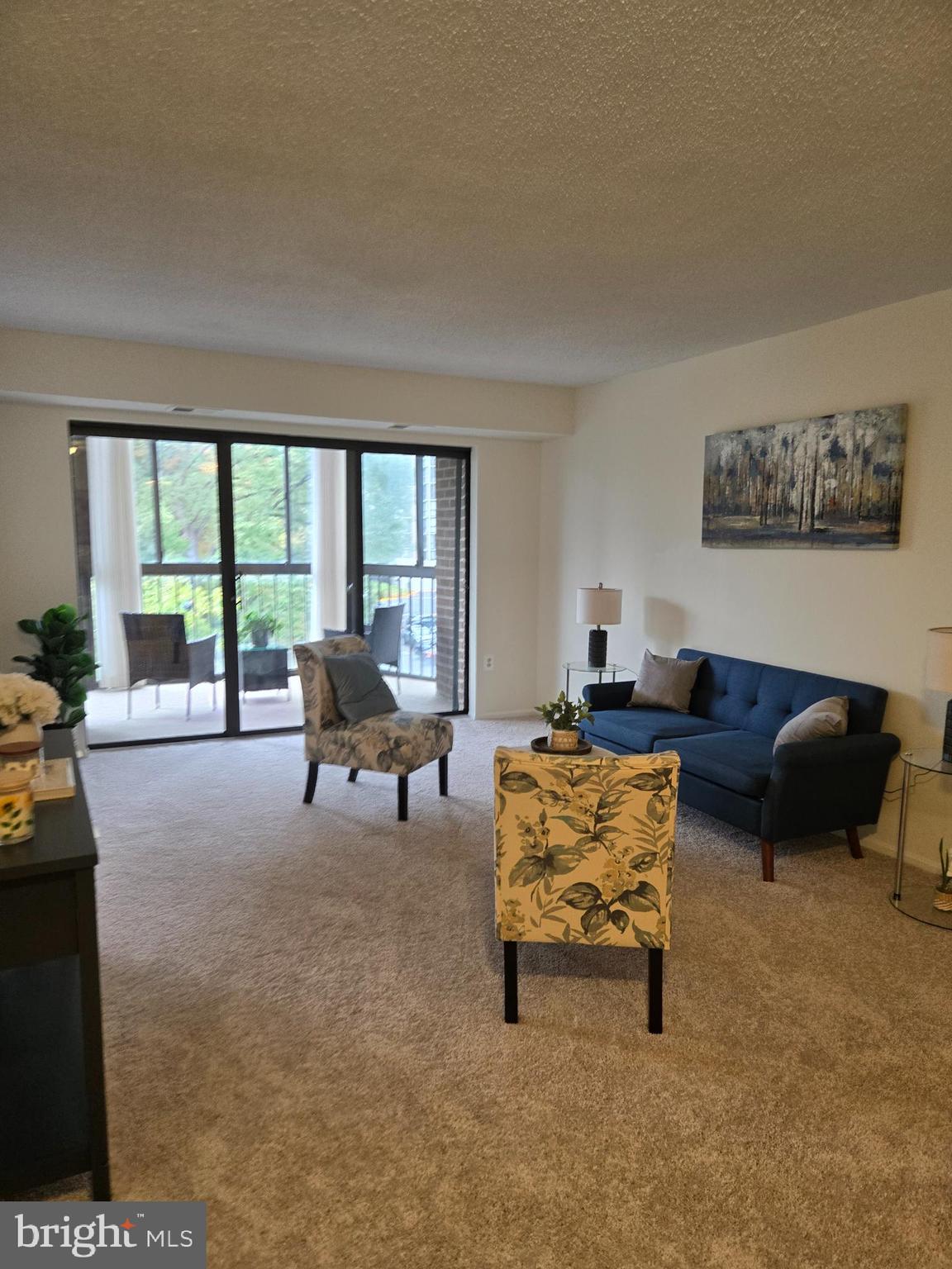 15107 Interlachen Drive, Unit 2321 Silver Spring, MD 20906 - Photo 1 of 35 a living room with furniture and a large window