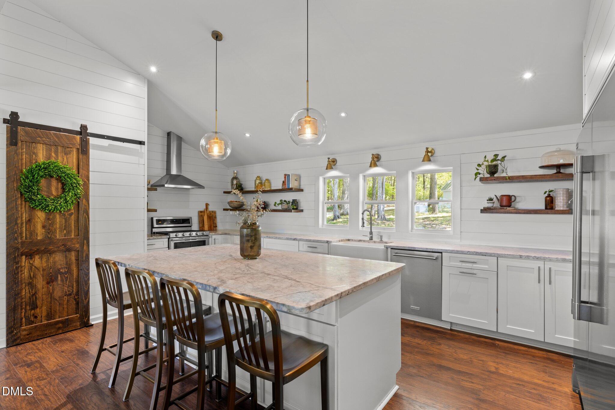 9400 Wheelers Church Road Cedar Grove, NC 27231 - Photo 15 of 96 a kitchen with stainless steel appliances granite countertop a sink a stove a refrigerator and island with wooden floor