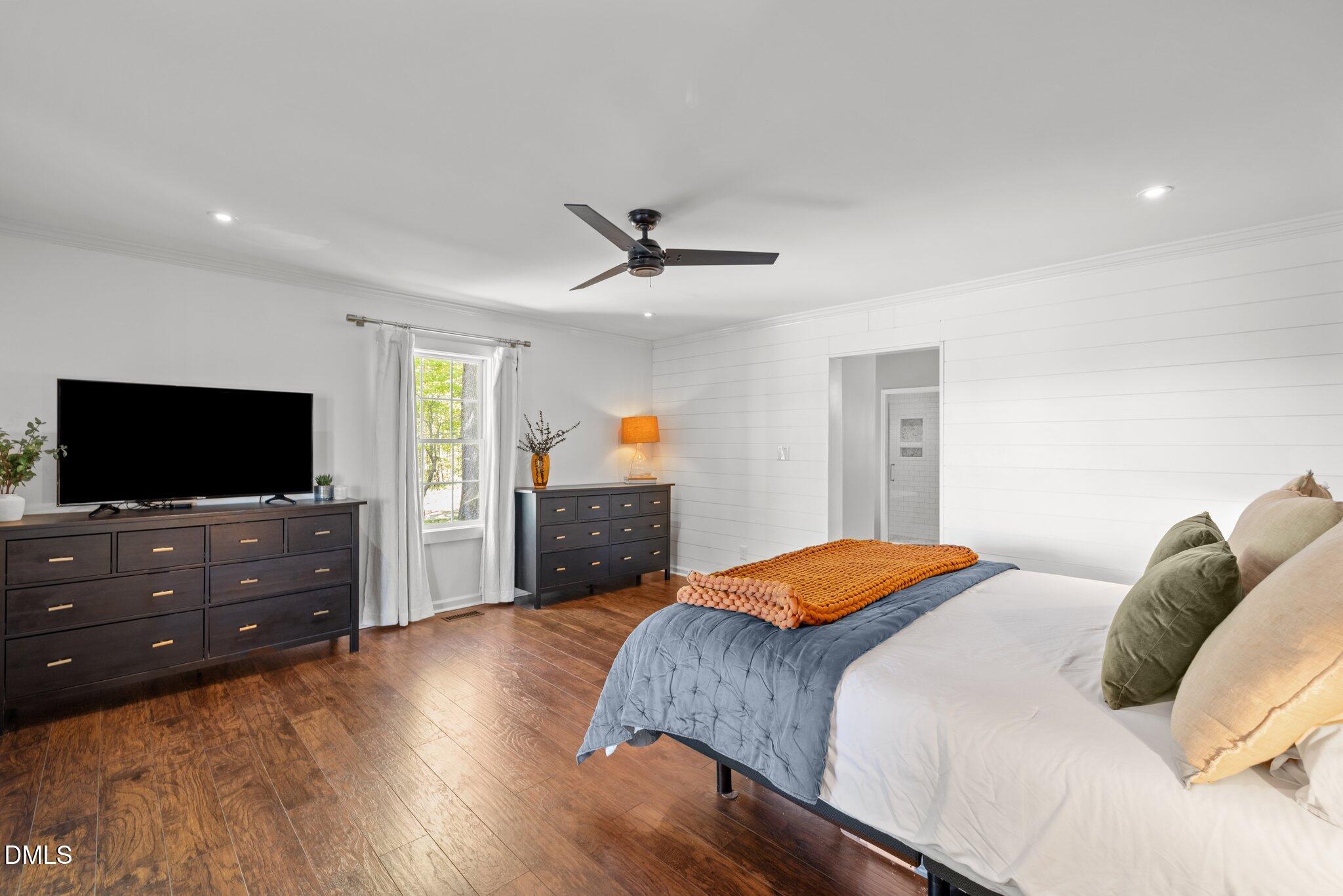 9400 Wheelers Church Road Cedar Grove, NC 27231 - Photo 26 of 96 a bedroom with a bed and a flat screen tv