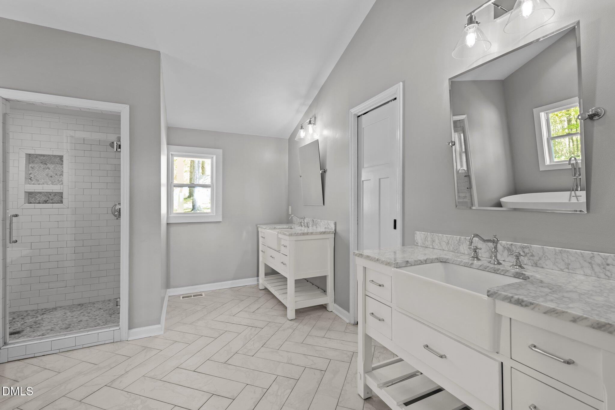 9400 Wheelers Church Road Cedar Grove, NC 27231 - Photo 27 of 96 a spacious bathroom with a granite countertop sink mirror and shower