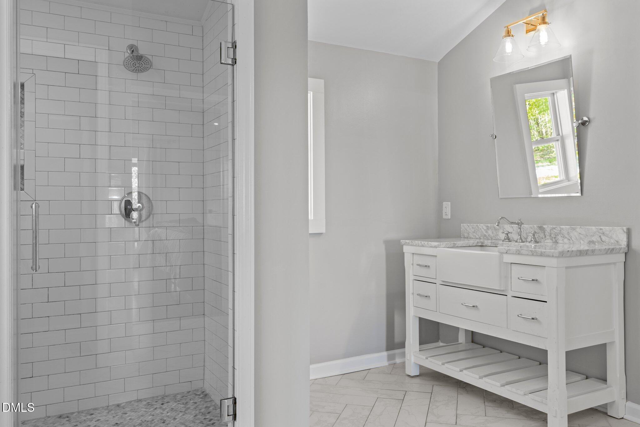 9400 Wheelers Church Road Cedar Grove, NC 27231 - Photo 29 of 96 a bathroom with a sink a mirror and shower