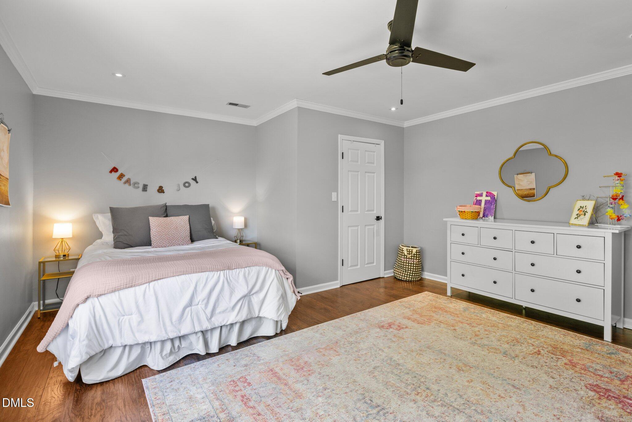 9400 Wheelers Church Road Cedar Grove, NC 27231 - Photo 35 of 96 a bedroom with a bed and chandelier