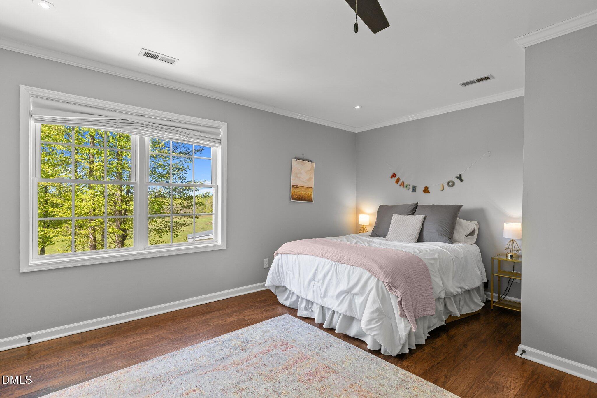 9400 Wheelers Church Road Cedar Grove, NC 27231 - Photo 36 of 96 a bedroom with a large bed and a window