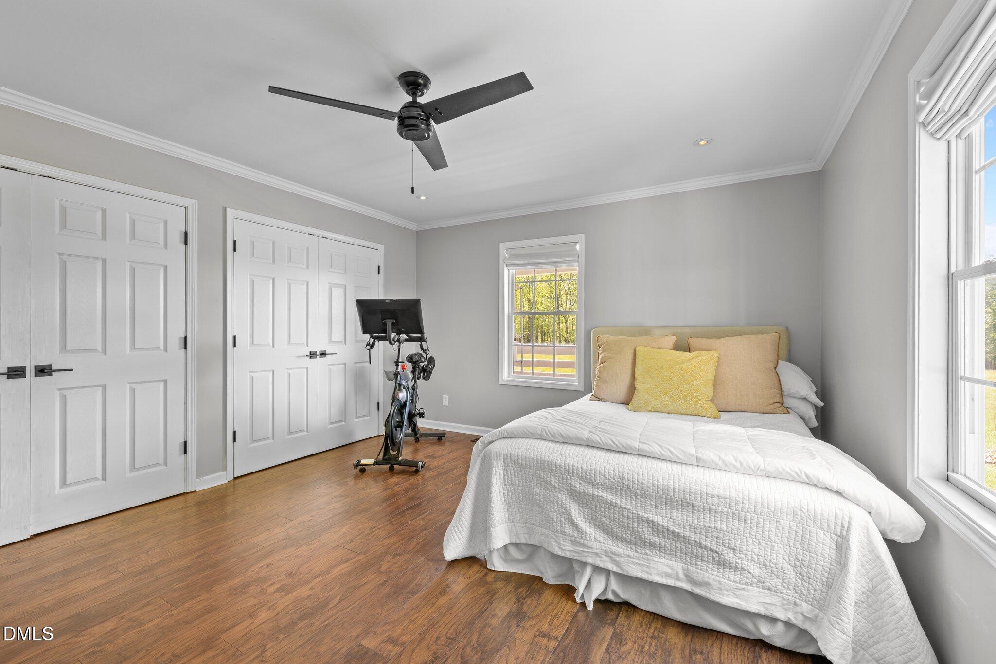 9400 Wheelers Church Road Cedar Grove, NC 27231 - Photo 37 of 96 a bedroom with a bed and a chandelier