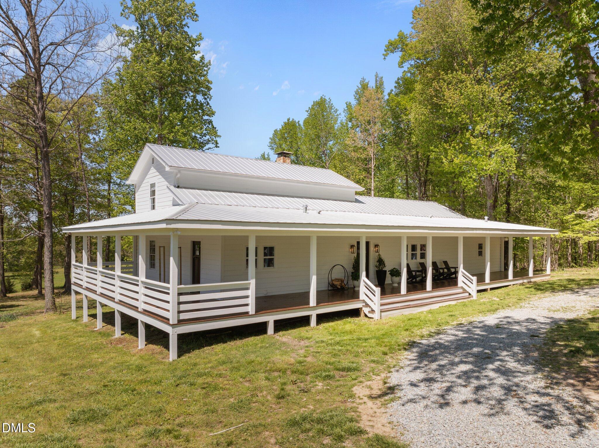 9400 Wheelers Church Road Cedar Grove, NC 27231 - Photo 7 of 96 a view of a house with a backyard and deck