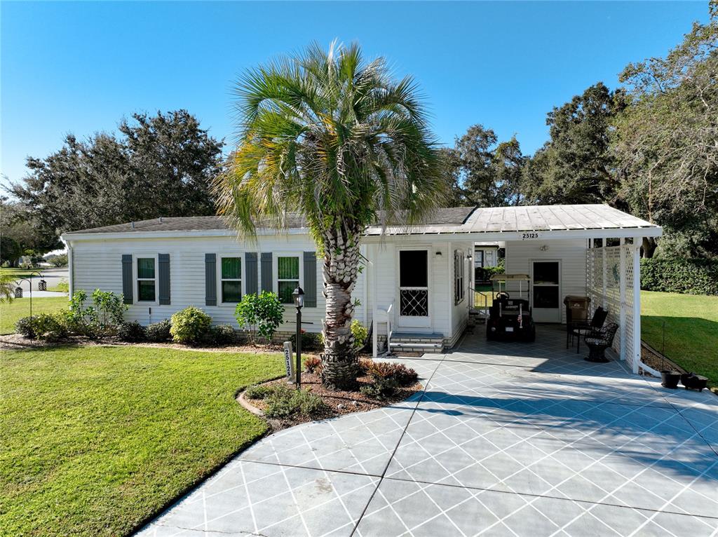 a view of a house with backyard sitting area and porch
