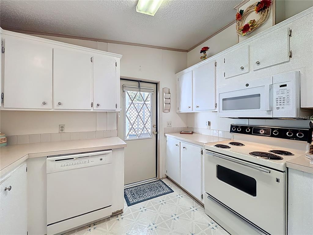 25125 Bellevue Leesburg, FL 34748 - Photo 18 of 44 a kitchen with cabinets appliances and a sink