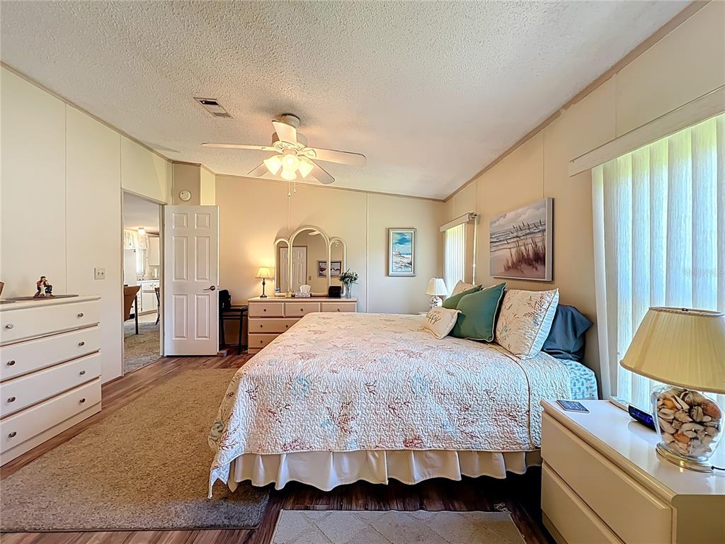 25125 Bellevue Leesburg, FL 34748 - Photo 25 of 44 a bedroom with a bed and ceiling fan