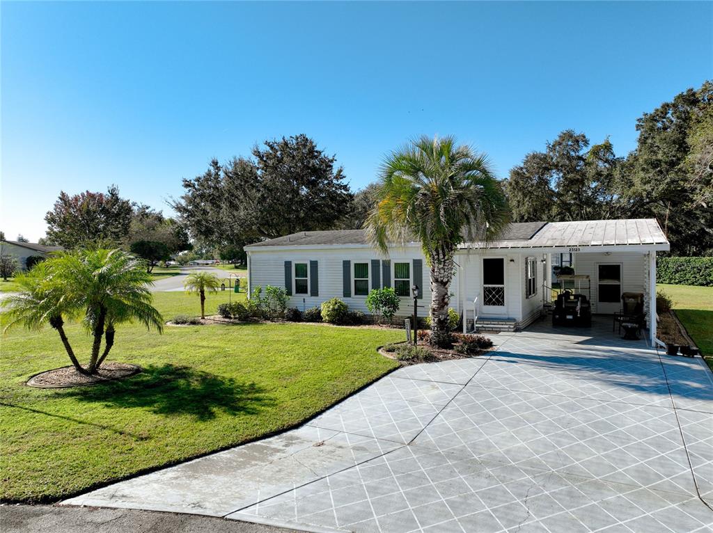 25125 Bellevue Leesburg, FL 34748 - Photo 3 of 44 a view of a house with backyard sitting area and garden
