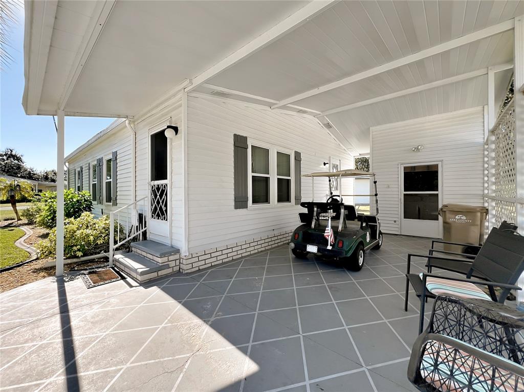 25125 Bellevue Leesburg, FL 34748 - Photo 36 of 44 a living room with couches a table and a fireplace with wooden floor