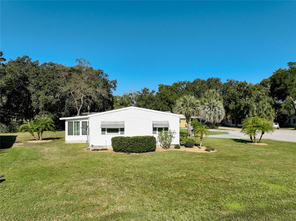 25125 Bellevue Leesburg, FL 34748 - Photo 37 of 44 a view of a house with backyard and trees